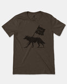 A dark brown heather short-sleeve t-shirt featuring a black graphic of a coyote carrying a 'STAY WILD' flag, displayed flat against a light gray background.