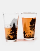 Two glasses with hunting-themed designs on a white background